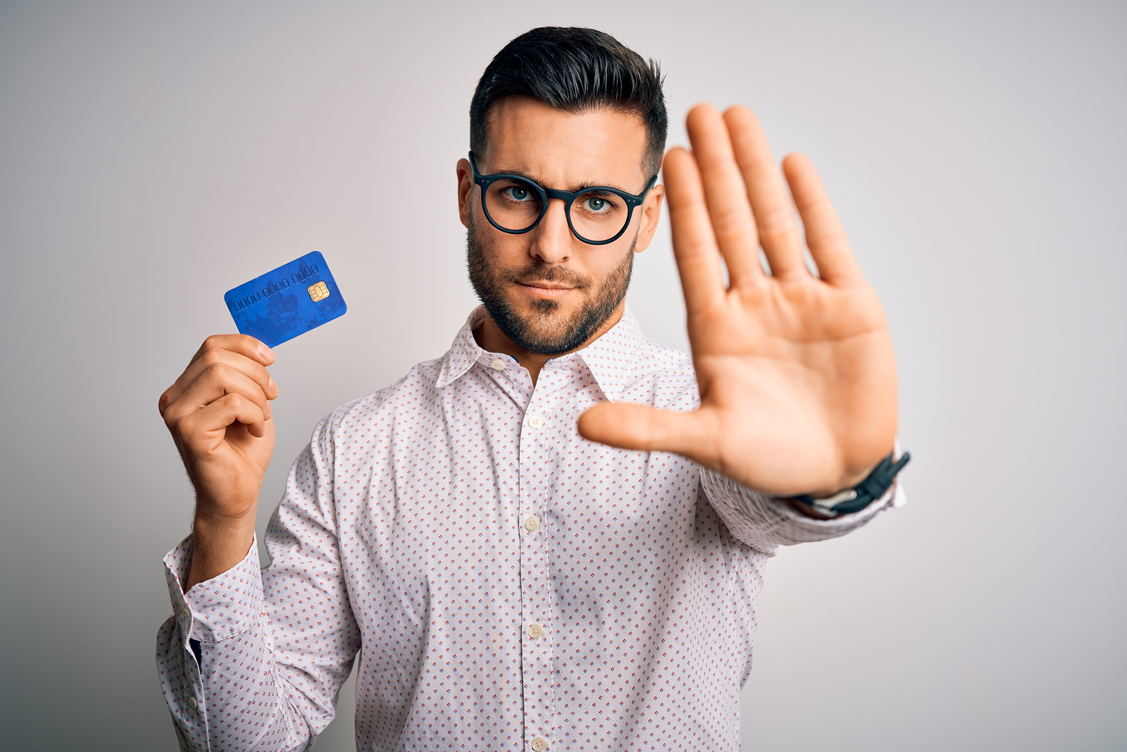 Работаем открытой рукой. Man holding credit Card. Man holding credit Card with Sad expersion.