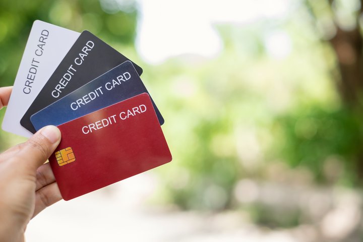 Credit Card hand holding best 0% credit cards of 2025 with green nature background and copy space
