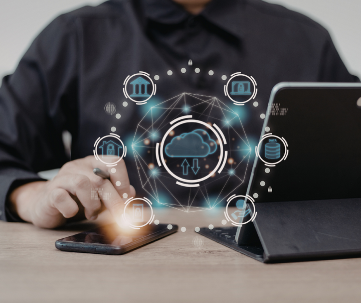 Entrepreneur using AI tools on laptop and smartphone to improve business efficiency and decision-making