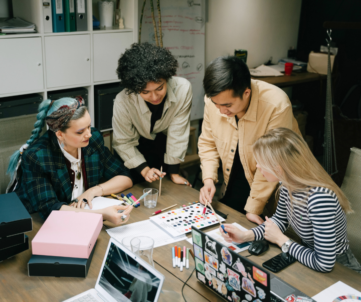 Business team collaborating on a marketing strategy, representing scaling marketing without burnout through systems and focused teamwork